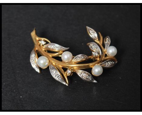 A hallmarked 18ct gold diamond and pearl spray brooch with diamond set leaves and pearl flowers having a roller clip clasp. H