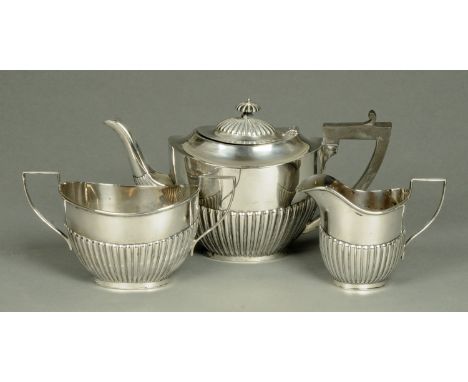 A three piece silver tea service, half lobed, Sheffield 1922, 1039 grams gross (see illustration).