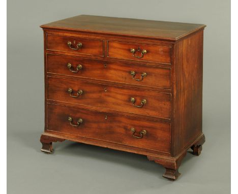 A George III mahogany chest of drawers, with moulded edge above two short and three long graduated drawers with brass drop ha