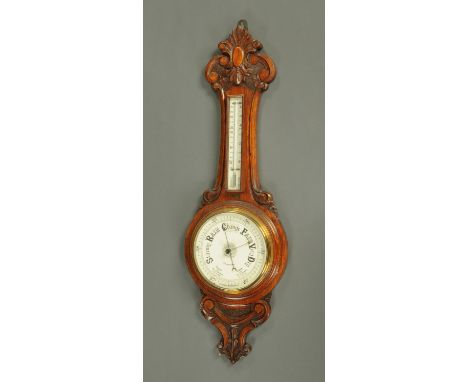 An oak aneroid barometer, with porcelain dial and mercury barometer, in carved case.  