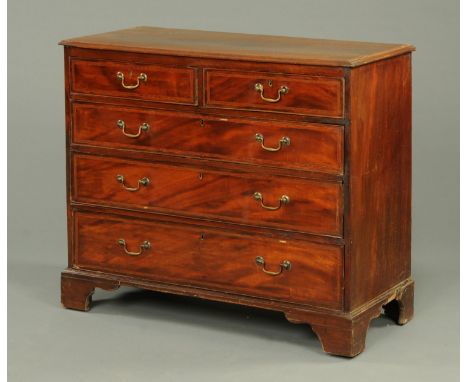 An early 19th century mahogany satinwood crossbanded chest of drawers, with two short and three long drawers with brass drop 