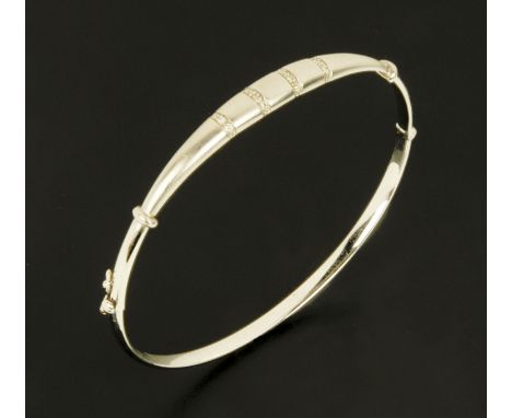 A 9 ct white gold bangle set with small diamond chips, 7.4 grams gross. 