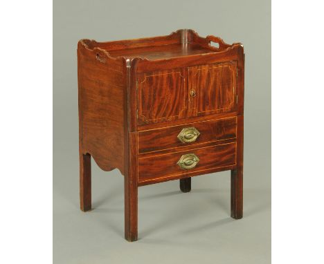 A George III mahogany bedside cabinet, formerly a commode, with tray type top above a cupboard door and false shelves and rai