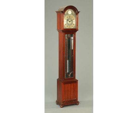 A mahogany longcase clock, with three-train weight driven movement striking on twelve gongs, with glazed trunk door and raise