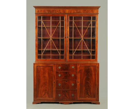 A George III mahogany bookcase, with detachable moulded cornice above a pair of glazed doors with wooden astragals enclosing 