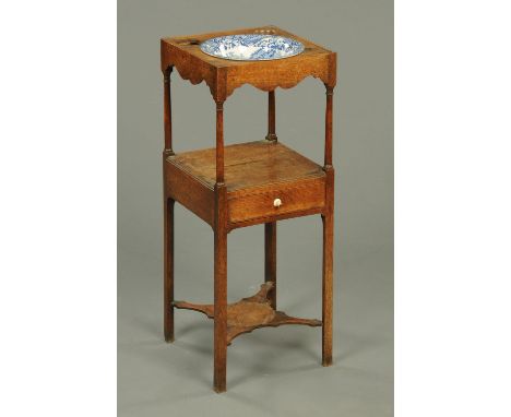 A George III oak washstand, with Copeland Spode basin, two tier, with single drawer and raised on chamfered legs united by st