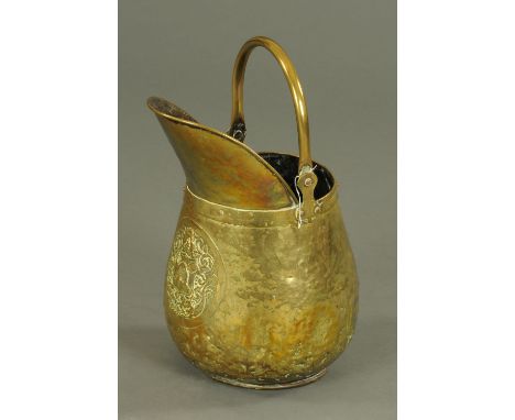 A 19th century armorial brass coal helmet.  Height 46 cm. 