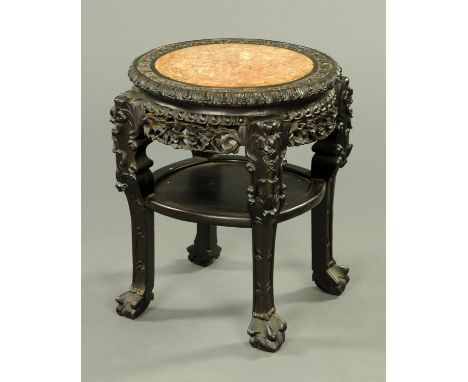 A 19th century Chinese hardwood jardiniere stand, with rouge marble top and shelf.  Diameter 46 cm.  CONDITION REPORT: The ma