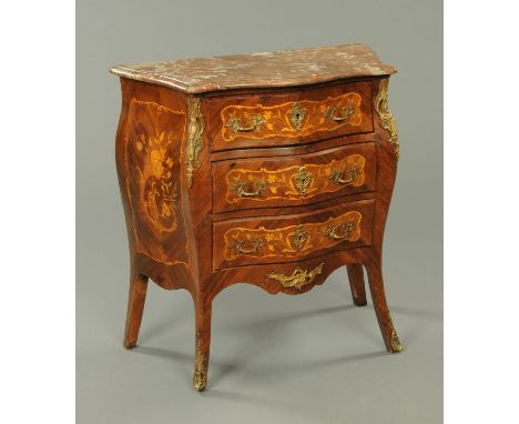 A late 19th century French marble topped commode chest, with three drawers with brass handles, with canted angles and raised 