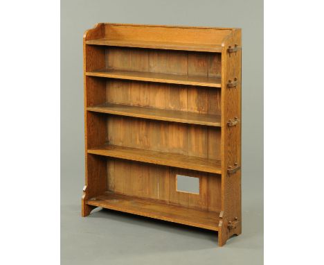 An oak open five tier shelf unit, early 20th century, with pegged shelves.  Width at widest point 105 cm. 