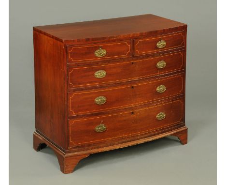 A George III inlaid mahogany bowfronted chest of drawers, with two short and three long drawers with brass drop handles with 