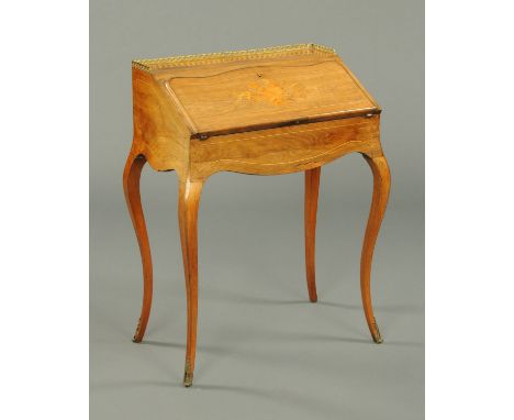 A Victorian rosewood ladies bureau, with pierced brass gallery, slope front, bow, quiver and arrow motif, the interior fitted