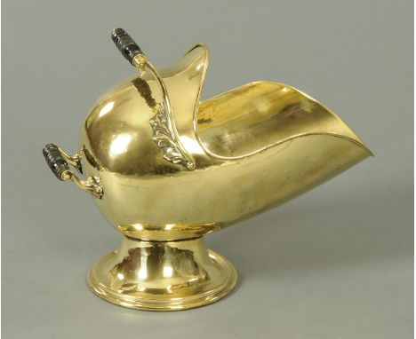 A Victorian brass coal helmet, with two carrying handles and raised on a circular base.  