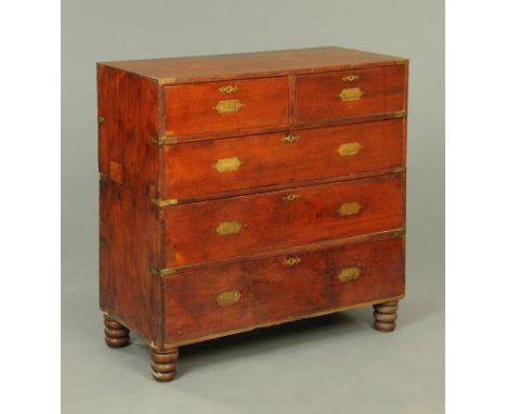 A 19th century Campaign chest of drawers, with two sections and with brass fittings and with detachable short turned legs.  W