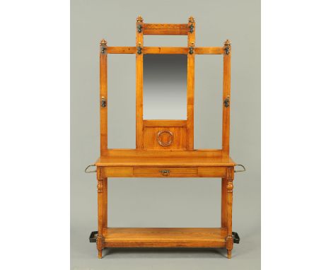 A late Victorian oak hall stand, with hooks, mirror, shelf, drawer and drip trays.  Width 177 cm (see illustration).  CONDITI