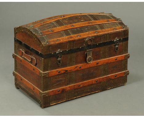 A late Victorian leather and wooden bound dome topped trunk, with striped lined interior.  Width 77 cm. 