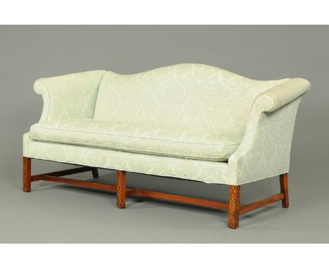 A George III style mahogany sofa, with rollover arms, squab cushion and raised on blind fret carved front legs.  Width 196 cm