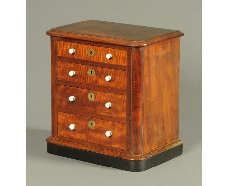 A Victorian mahogany miniature chest of drawers, with moulded edge and rounded corners and fitted with four drawers with cera