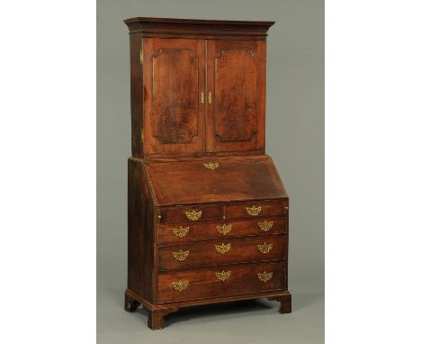 A George III mahogany and walnut bureau bookcase, with moulded cornice above a pair of panelled doors enclosing shelves, the 