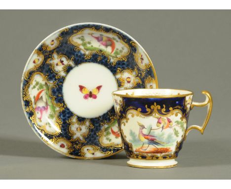 An 18th century Worcester cup and saucer, with blue scale decoration of birds and butterflies, square hatched mark to saucer.