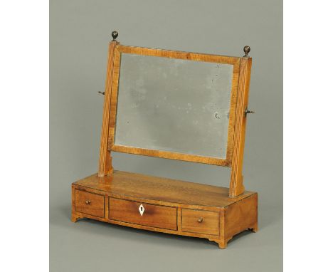 A 19th century mahogany framed toilet mirror, rectangular, with bowfronted base fitted with drawers and raised on bracket fee