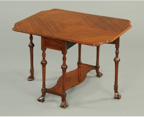 A mahogany twin drop flap Sutherland table, circa 1930, with book matched veneers and raised on turned legs united by a low s