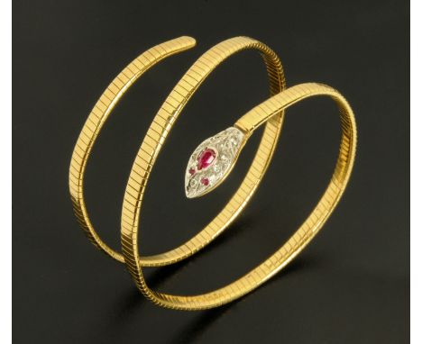 An 18 ct gold ruby and diamond set snake coiled bangle, 33.8 grams gross (see illustration). 