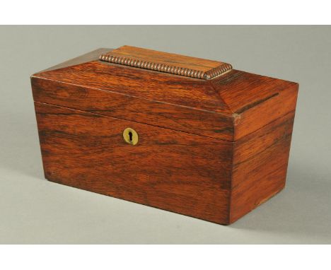 A Regency rosewood sarcophagus shaped tea caddy, with two interior compartments and centre aperture.  Width 28 cm. 