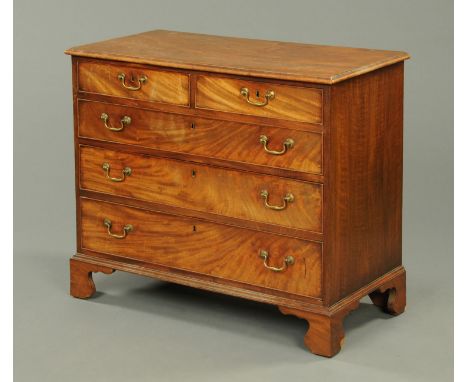 A George III mahogany chest of drawers, with two short and three long graduated drawers with brass drop handles and cockbeadi