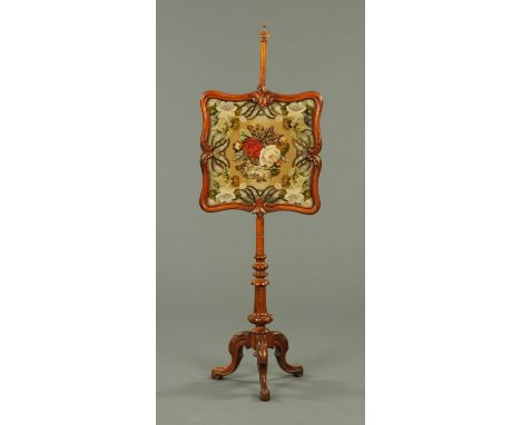 A Victorian mahogany pole screen, with beadwork and tapestry screen, with turned column with three downswept legs terminating