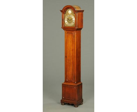 A walnut cased grandmother clock, with arched hood enclosing the silvered brass dial with three-train spring driven movement 
