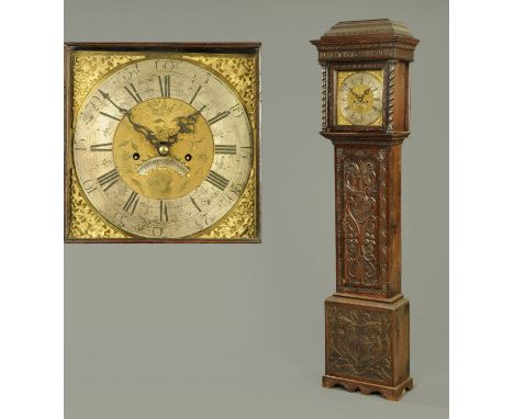 An oak longcase clock, with carved case inscribed "Use Time Wisely" and with silvered brass dial and two-train striking movem