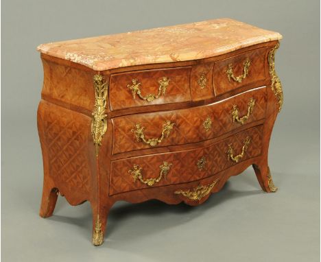 An early 20th century French parquetry bombe commode chest, with serpentine variegated marble top, fitted with a series of fr