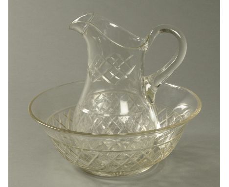 A cut glass toilet jug and basin. CONDITION REPORT: The jug has two minor flea bites towards the spout the bowl has a very sm