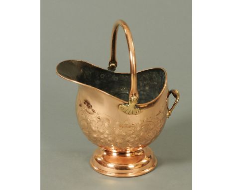 A Victorian embossed copper coal helmet, with loop carrying handle (see illustration).