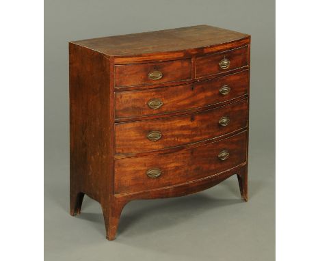 A George III mahogany bowfronted chest of drawers, crossbanded and inlaid and with two short and three long graduated drawers