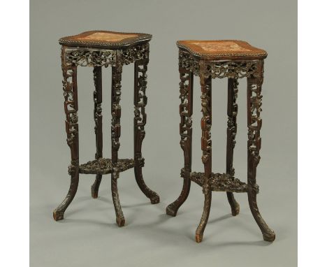 A pair of 19th century Chinese hardwood jardiniere stands, each of shaped outline and with rouge marble top raised on four le