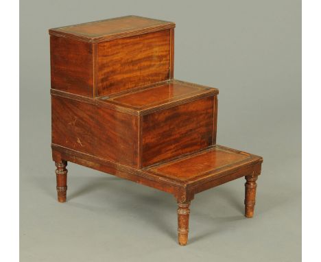 A George III mahogany three step commode, with tooled leather treads and raised on turned legs.  Width 47 cm. 