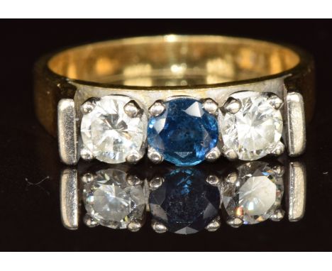 An 18ct gold ring set with a round cut sapphire of approximately 0.3ct&nbsp;and two round cut diamonds, each approximately 0.