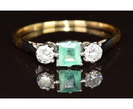 An 18ct gold ring set with an emerald and two round cut diamonds, each approximately 0.15ct, 2g, size U