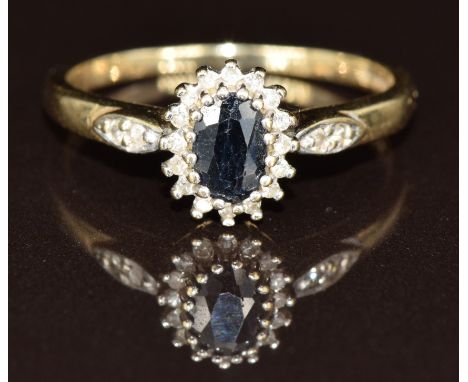 A 9ct gold ring set with an oval cut sapphire surrounded by diamonds, 2.4g, size Q
