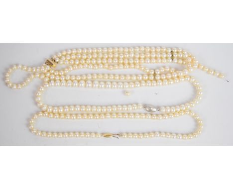 A single strand of cultured pearls with 14k gold clasp, three strand cultured pearl necklace with 14k gold clasp and a single