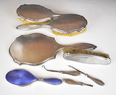Hallmarked silver dressing table items comprising hand mirror, three brushes, button hook and two other silver handled tools 