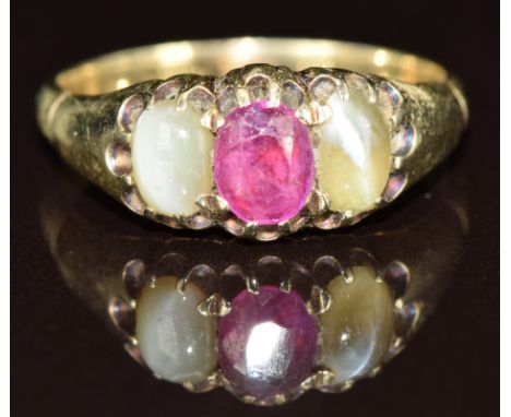 A 9ct gold ring set with an oval cut ruby and two chrysoberyl cabochons, 4g, size O