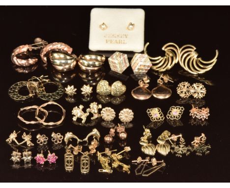 Twenty six pairs of 9ct gold earrings including hoops, tri-coloured, ruby cluster, hearts, flowers, stars, etc, 17g