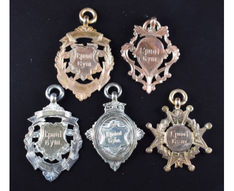 Five Liverpool Gym medals, comprising three hallmarked 9ct gold examples and two hallmarked silver examples, all marked to re