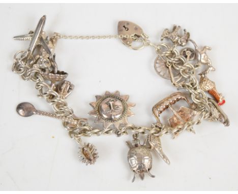 A silver charm bracelet with fifteen silver charms including teddy bear, plane, camera, donkey, etc, 49.1g