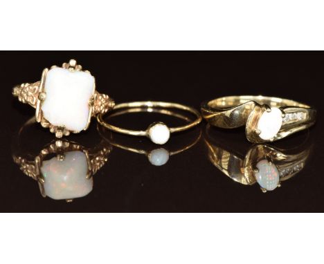 Three 9ct gold rings each set with an opal, 6g, size O, G &amp; M