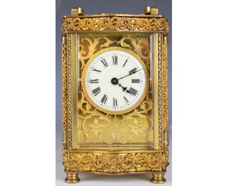 Gilt metal cased carriage clock with bevelled glass and white enamel and gilt fretwork dial, height including handle&nbsp;16c