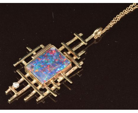 A 1970's 9ct gold pendant set with a black opal triplet and a diamond (5cm) on 9ct gold chain, 7.1g,&nbsp;